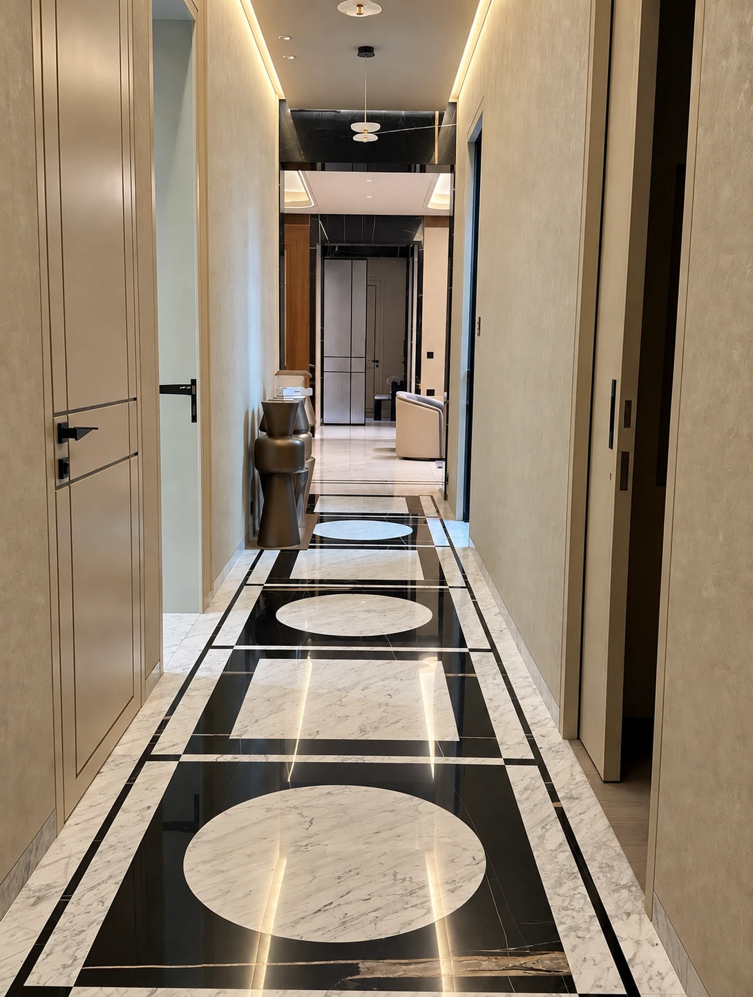 Double-height lobby with a mirrored ceiling and glass staircase executed by JRT