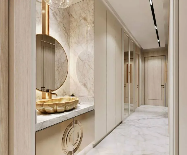 Stone vanity with a sculpted basin and fluted joinery