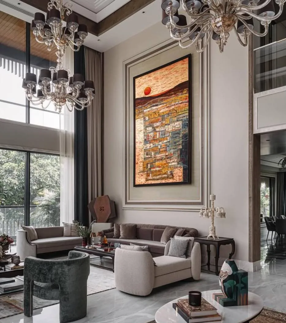 Double-height living room with a statement artwork and sculptural chandeliers